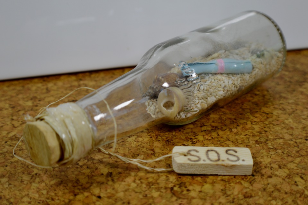 A message in a bottle with an S.O.S tag.